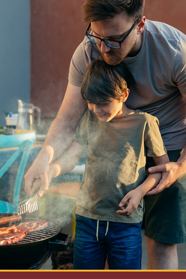 Dad and son at the grill Dad and son at the grill